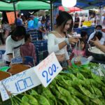 A market stall piled with fresh vegetables