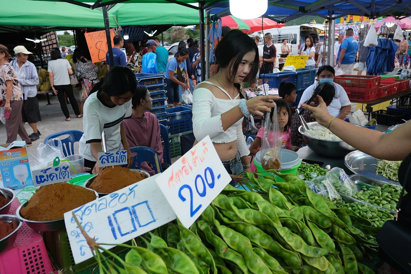 A market stall piled with fresh vegetables